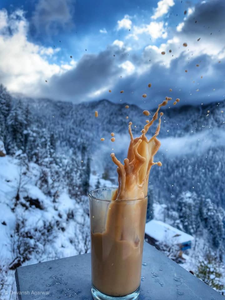 Splashing tea on the backdrop of Icy Himalayas.
